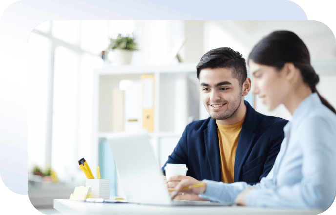 Two therapists reviewing HIPAA-compliant intake forms on a laptop